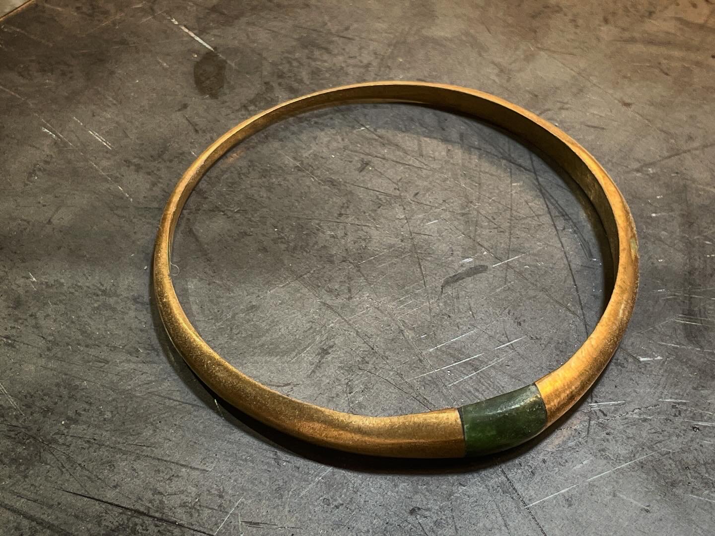 Bronze bangle with inset green pounamu