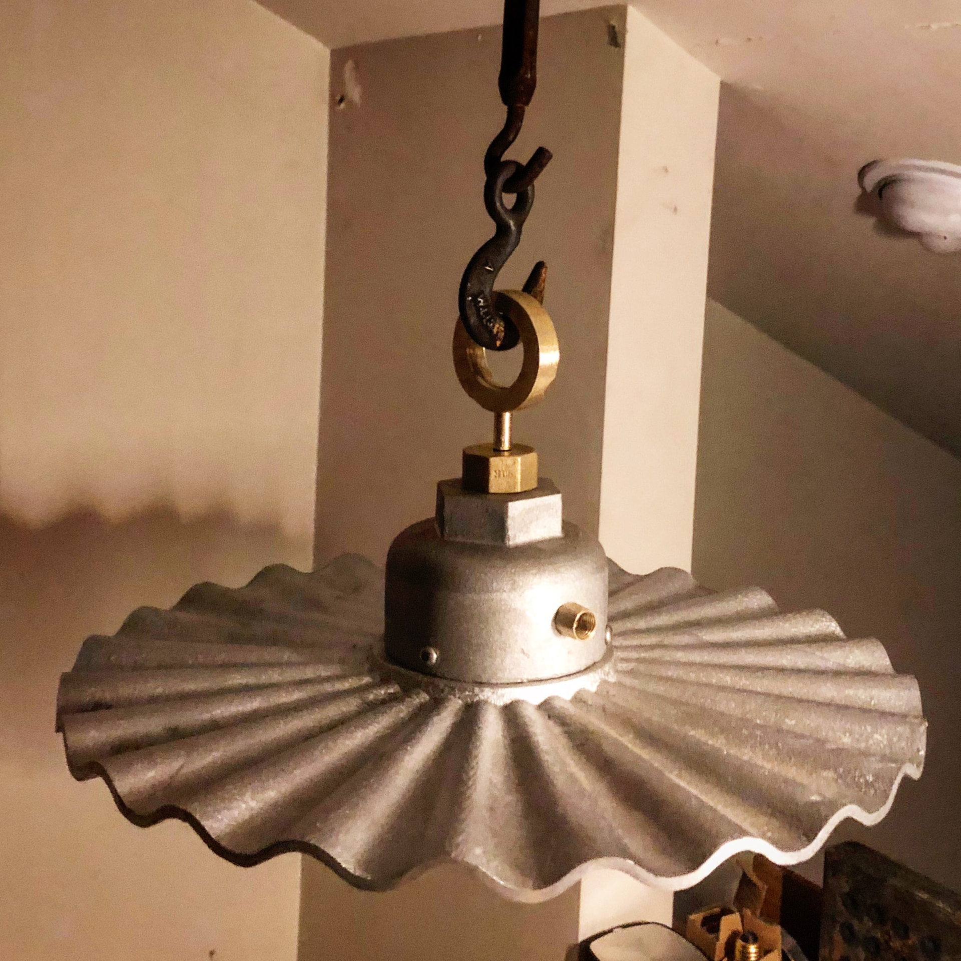 Pressed steel pendant shade with brass hanging hardware – detail