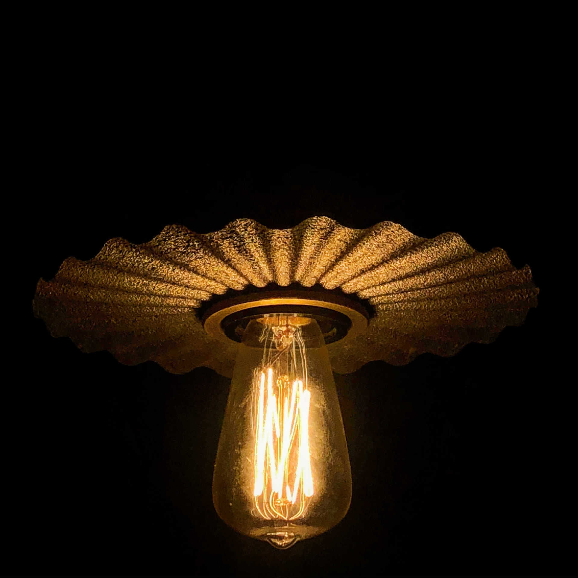 Pendant shade lit at night with filament bulb