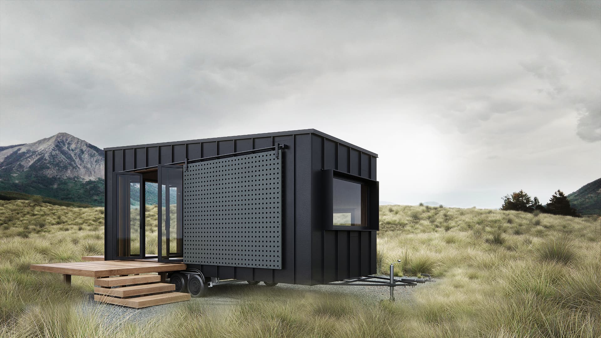 Compact dark-clad modular dwelling with a dark sliding screen and timber entrance steps
