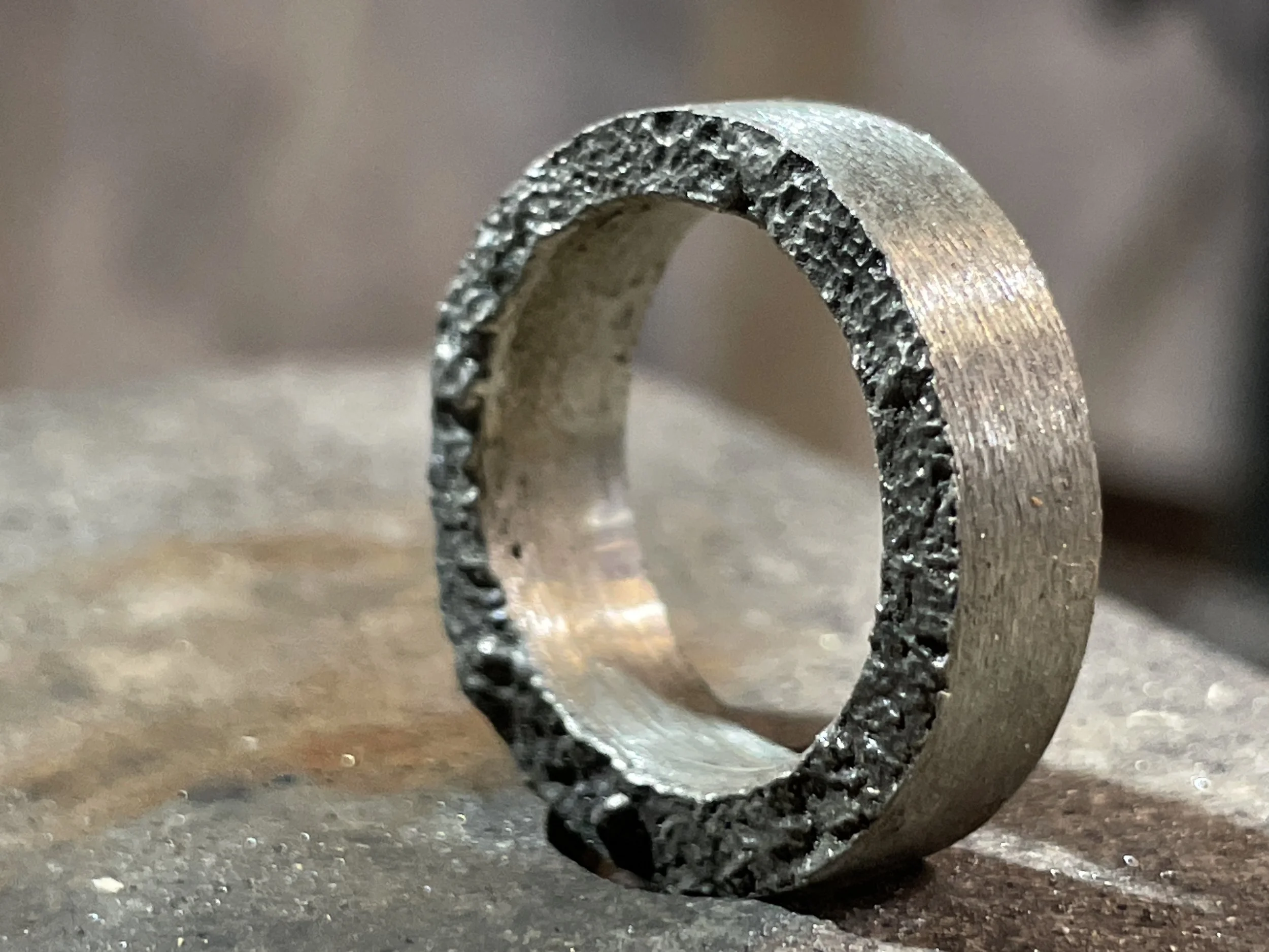 Hand-finished ring with textured outer edge