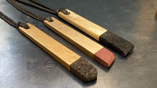 Hand-shaped oak pendants tipped with lava stone