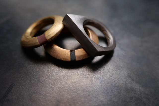 Three hand-finished rings in timber and dark metal