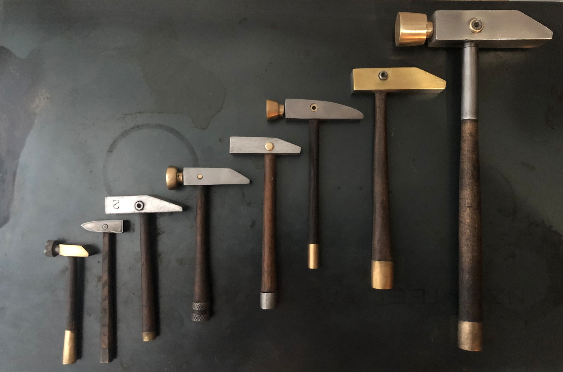Handmade brass and steel hammers with timber handles